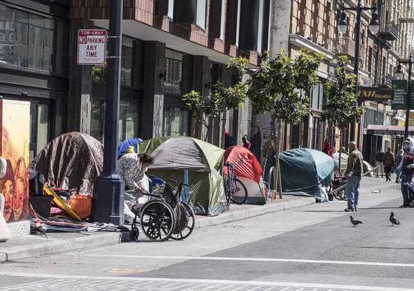 Tents and homeless occupy the sidewalk on Eddy Street in the Tenderloin district of San Francisco on Friday, April 3, 2020. San Francisco is trying to spread out their homeless to avoid the coronavirus.  SXP2020040314 TERRYxSCHMITT