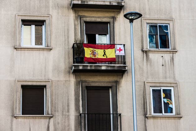 April 3, 2020, Madrid, Spain: A Spanish flag with a blag crepe hang on a balcony..Madrid is the most affected capital in the world by the pandemic. The coronavirus (COVID-19) has spread to at least 182 countries, claiming over 55,000 lives and infecting thousands more. In Spain the number of deaths is over 11,000 now. Madrid Spain - ZUMAs197 20200403_zaa_s197_323 Copyright: xBraisxG.xRoucox