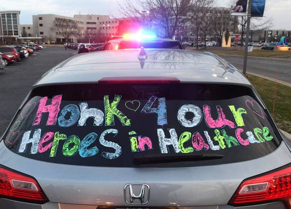 April 3, 2020, Racine, Wisconsin, USA: Hundreds of cars packed the campus of Ascension All Saints Hospital in Racine, Wisconsin Friday April 3, 2020 to show their support to the staff. The event, suggested by a NICU nurse, for cars to parade through the grounds flashing their headlights, was billed as Flashin First Friday because the traditional downtown First Fridays during which stores stay open late was canceled. So many cars came that the parade stalled that most cars just parked facing the hospital buildings and honked their horns for an hour. Racine County reported its first COVID-19 death Friday. Racine USA - ZUMAh154 20200403_znp_h154_009 Copyright: xMarkxHertzbergx