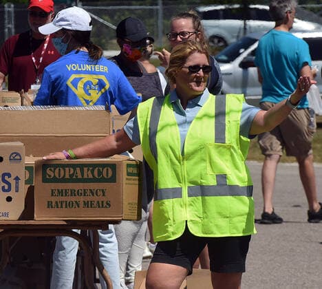 April 3, 2020, Groveland, Florida, United States: Volunteers prepare packages of food items from the Second Harvest Food Bank of Central Florida for distribution to needy families at a drive through event that served over 350 families at the Faith Neighborhood Center near Orlando. The coronavirus pandemic has put thousands of local service employees and theme park workers out of work, placing a strain on area food banks. Groveland United States - ZUMAs197 20200403_zaa_s197_350 Copyright: xPaulxHennessyx