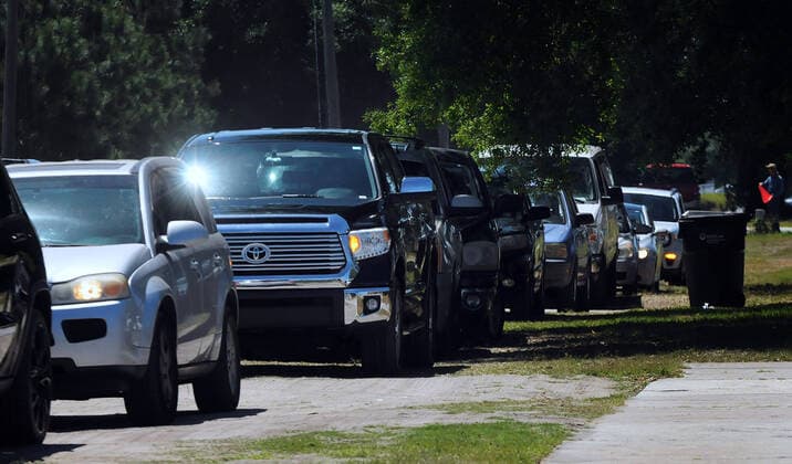 April 3, 2020, Groveland, Florida, United States: A line of cars backs up as people arrive to pick up food items from the Second Harvest Food Bank of Central Florida at a drive through event for needy families at the Faith Neighborhood Center near Orlando. The coronavirus pandemic has put thousands of local service employees and theme park workers out of work, placing a strain on area food banks. Groveland United States - ZUMAs197 20200403_zaa_s197_352 Copyright: xPaulxHennessyx