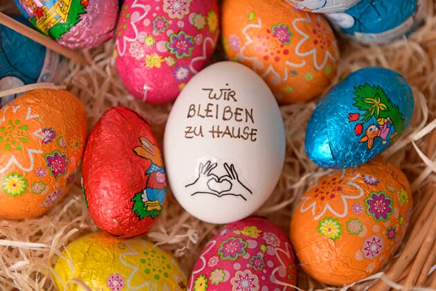 04.04.2020, Symbolbild: An Ostern 2020 bleiben wir zu Hause. Slogan Wir bleiben zu Hause auf einem Hühnerei im Osternest. Aktion wegen der Corona-Krisen-Ausgangsbeschränkung in Deutschland. 04.04.2020, Ostern zuhause bleiben 04.04.2020, Ostern zuhause bleiben