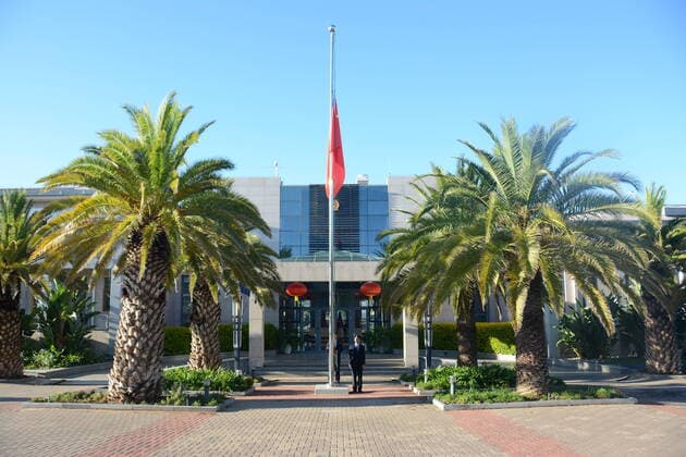 (200404) -- WINDHOEK, April 4, 2020 -- A Chinese national flag flies at half-mast to mourn for martyrs who died in the fight against the novel coronavirus disease (COVID-19) outbreak and compatriots who died of the disease at the Chinese Embassy to Namibia in Windhoek, Namibia, April 4, 2020. (Photo by Xinhua) NAMIBIA-WINDHOEK-COVID-19-CHINESE EMBASSY-NATIONAL FLAG-HALF-MAST XiexDongdong 