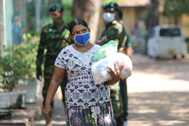 April 4, 2020, Colombo, Sri Lanka: A Sri Lanken woman carries packages of dry rations of food and commodities distributed by Sri Lankan police Special Task Force during the island-wide curfew..The Sri Lankan government has implemented an island-wide curfew until further notice in order to slow down the spread of the SARS-CoV-2 coronavirus that causes the COVID-19 disease. To date Sri Lanka has confirmed at least 162 novel coronavirus infections with five deaths and 25 recovered. Colombo Sri Lanka - ZUMAs197 20200404_zaa_s197_071 Copyright: xHarshanaxJohanasx