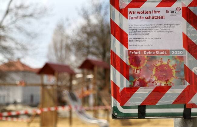 Corona 04.04.2020 , Erfurt, die Innenstadt ist aufgrund der Corona-Krise wie ausgestorben, die Menschen sollen so gut es geht, zu Hause bleiben im Bild: ein Hinweisschild am Spielplatz hinter der Krämerbrücke weist auf die Sperrung und das Corona-Virus hin - alle Spielplätze sind aufgrund der Pandemie gesperrt