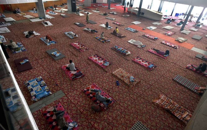 NEW DELHI, INDIA APRIL 4: Migrant workers and the homeless rest while maintaining distance at a temporary shelter, on day eleven of the nationwide lockdown to check the spread of coronavirus, at Yamuna Sports Complex, on April 4, 2020 in New Delhi, India. (Photo by Sonu Mehta Hindustan Times ) India Goes Into 21 Day Lockdown Due To Coronavirus COVID 19