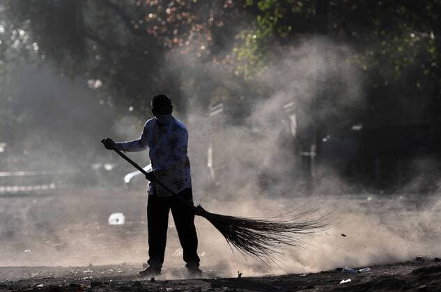 NEW DELHI, INDIA APRIL 4: A man sweeps a floor on day eleven of the 21 day nationwide lockdown to curb the spread of coronavirus, at Daryaganj, on April 4, 2020 in New Delhi, India. (Photo by Biplov Bhuyan Hindustan Times ) India Goes Into 21 Day Lockdown Due To Coronavirus COVID 19
