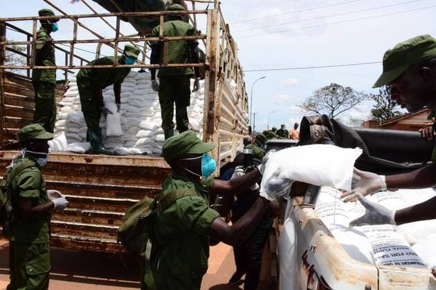 (200404) -- KAMPALA, April 4, 2020 (Xinhua) -- Military personnel unload relief food from a truck in Kampala, capital of Uganda, April 4, 2020. Uganda on Saturday started relief food distribution to about 1.5 million urban poor who are affected by the lockdown as a measure to contain the COVID-19 outbreak in the country. (Photo by Nicholas Kajoba Xinhua) UGANDA-KAMPALA-RELIEF FOOD DISTRIBUTION-COVID-19 