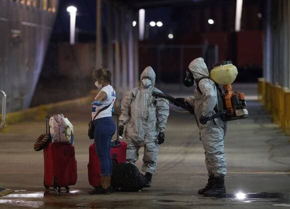 A woman on board the Marella Discovery 2 cruise ship is disinfected after the docking of the ship is authorized for humanitarian reasons for the disembarkation of 32 members of his crew who are Dominican citizens, and who asked to return to the country instead of continuing the sailing trip to Europe, this Saturday in Santo Domingo, Dominican Republic 4 April 2020. The 32 people will be transferred directly to a quarantined social isolation center, in order to comply with the Protocol established by the Ministry of Public Health. The number of deaths in the Dominican Republic from the coronavirus rose to 77 people, while 1,578 are infected, as of today. Landing of the Marella Discovery 2 cruise ship for Dominican crew and citizens !ACHTUNG: NUR REDAKTIONELLE NUTZUNG!  Copyright: xOrlandoxBarríax AME299 20200405-637216578897197592