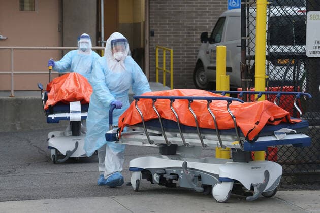 April 4, 2020, New York City, NY, United States: A procession of the dead emerges from the backdoor of Wyckoff Heights Medical Center. Hospital workers push the gurneys carrying the recently deceased to a temporary morgue inside refrigerated container trucks. Their lives were all claimed by COVID-19 or the novel Coronavirus. New York USA - ZUMAh16_ 20200404_zaf_h16_022 Copyright: xDanxHerrickx