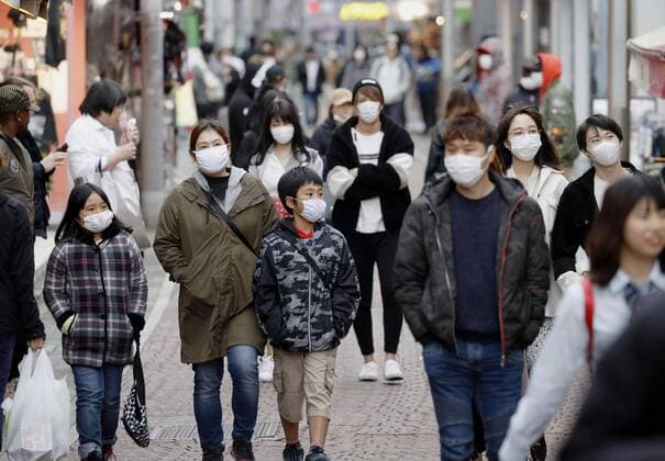 New coronavirus Masked people walk in Tokyo s Harajuku shopping area on April 5, 2020, amid the spread of the new coronavirus. 