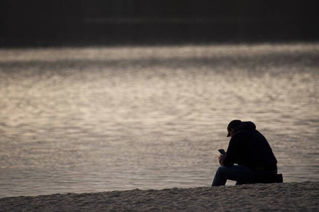 Ein Mann sitzt allein am Strand vom Berzdorfer See in Goerlitz, 04.04.2020. Aufgrund der Verbreitung des Coronaviruses gibt es deutschlandweit Ausgangsbeschraenkungen. Goerlitz Deutschland
