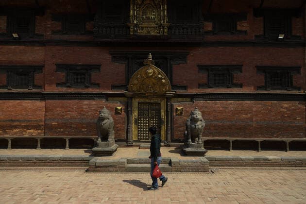 Lockdown in Nepal due to COVID-19 Man walks in an empty Patan Durbar Square, a UNESCO World Heritage Site during the nationwide lockdown in Lalitpur, Nepal on Sunday, April 05, 2020. The government of Nepal has decided to impose a nationwide lockdown to prevent the spread of Coronovirus (COVID-19) outbreak. Bagmati Nepal Copyright: SubashxShrestha