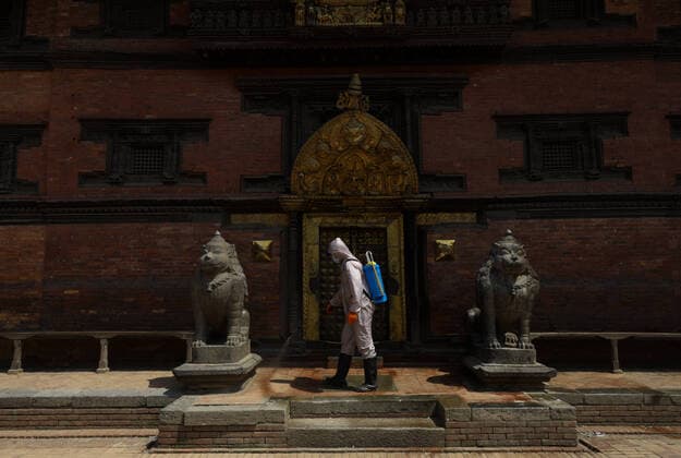 Lockdown in Nepal due to COVID-19 A Nepalese volunteer sprays disinfectants at Patan Durbar Square, a UNESCO World Heritage Site during the nationwide lockdown in Lalitpur, Nepal on Sunday, April 05, 2020. The government of Nepal has decided to impose a nationwide lockdown to prevent the spread of Coronovirus (COVID-19) outbreak. Bagmati Nepal Copyright: SubashxShrestha
