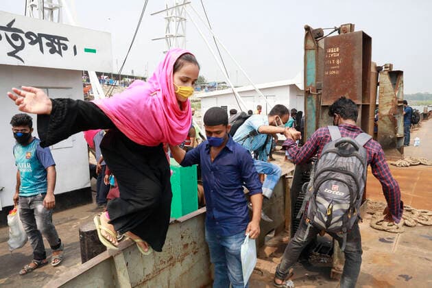 April 5, 2020, Mawa, Dhaka, Bangladesh: Thousands of readymade garment workers from across the country had either walked or used alternative modes of transpiration to reach capital Dhaka over the past few days, as owners decided to open the factories amid a government-enforced soft shutdown to prevent the novel coronavirus from spreading further. But following harsh criticisms, BGMEA was forced to keep the factories closed until April 11. The workers were told to go back home when they went to the factories to join work on Sunday morning. These photoss of people returning to their village homes were taken at the Shimulia ferry terminal in Mawa, near Dhaka, Bangladesh, April 05, 2020. Mawa Bangladesh - ZUMAd117 20200405_zap_d117_002 Copyright: xSuvraxKantixDasx