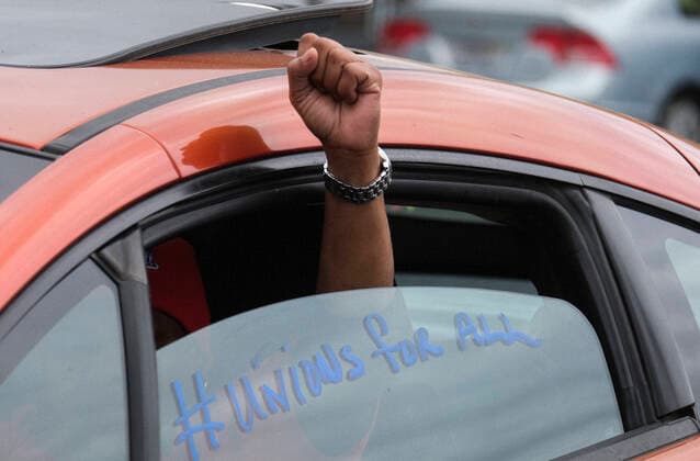 April 5, 2020, Los Angeles, California, U.S: A worker takes part in a drive-thru strike at a McDonald s restaurant on Sunday, April 5, 2020 in Los Angeles. The workers are demanding a two-week quarantine period, with full pay for a co-worker who tested positive for COVID-19. Los Angeles U.S. - ZUMAc68_ 20200405_zaf_c68_001 Copyright: xRingoxChiux