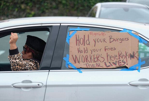 April 5, 2020, Los Angeles, California, U.S: A worker takes part in a drive-thru strike at a McDonald s restaurant on Sunday, April 5, 2020 in Los Angeles. The workers are demanding a two-week quarantine period, with full pay for a co-worker who tested positive for COVID-19. Los Angeles U.S. - ZUMAc68_ 20200405_zaf_c68_015 Copyright: xRingoxChiux
