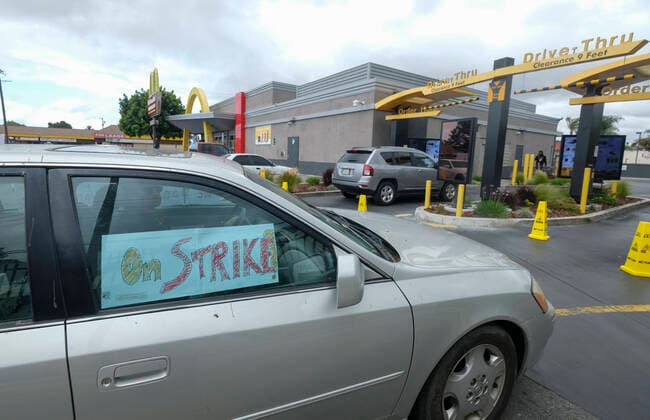 April 5, 2020, Los Angeles, California, U.S: Workers take part in a drive-thru strike at a McDonald s restaurant on Sunday, April 5, 2020 in Los Angeles. The workers are demanding a two-week quarantine period, with full pay for a co-worker who tested positive for COVID-19. Los Angeles U.S. - ZUMAc68_ 20200405_zaf_c68_017 Copyright: xRingoxChiux