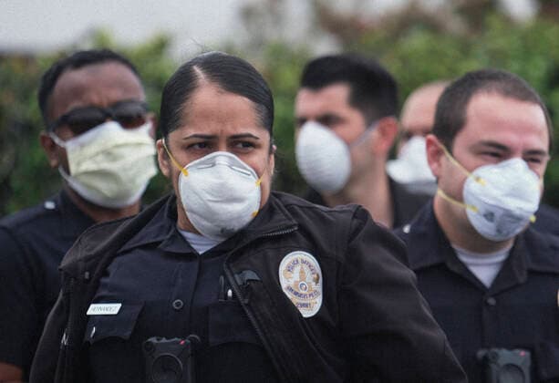 April 5, 2020, Los Angeles, California, U.S: Police officers wearing face masks as workers take part in a drive-thru strike at a McDonald s restaurant on Sunday, April 5, 2020 in Los Angeles. The workers are demanding a two-week quarantine period, with full pay for a co-worker who tested positive for COVID-19. Los Angeles U.S. - ZUMAc68_ 20200405_zaf_c68_018 Copyright: xRingoxChiux