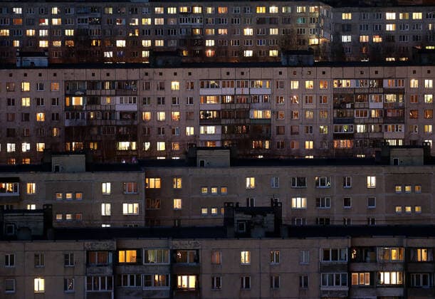ST PETERSBURG, RUSSIA - APRIL 5, 2020: Lit windows in apartment blocks in Nevsky District. A home isolation order was declared for St Petersburg residents of all ages to restrict movement within the city and reduce the risk of coronavirus contagion, effective since March 30, 2020; a period off work with full pay was extended until April 30 nationwide as part of preventive measures to contain the spread of the COVID-19 infection. Peter Kovalev TASS  TS0D47FF