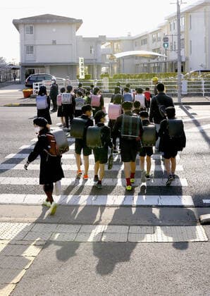 New coronavirus Elementary school students head to school in Saga, southwestern Japan, on April 6, 2020, as the new school year begins. Elementary and high schools had been closed in Japan since early March due to the coronavirus outbreak. 