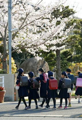 New coronavirus Elementary school students head to school in Saga, southwestern Japan, on April 6, 2020, as the new school year begins. Elementary and high schools had been closed in Japan since early March due to the coronavirus outbreak. 