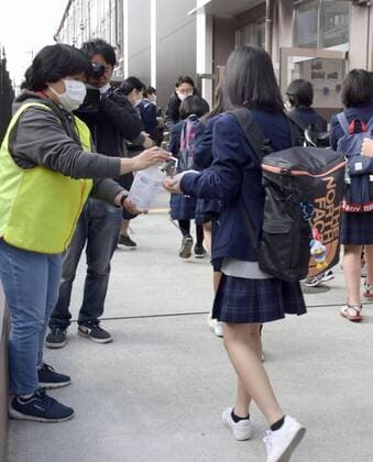 New coronavirus Junior high school students disinfect their hands before entering the school building in Kyoto, western Japan, on April 6, 2020, as the new school year begins. Elementary and junior high schools had been closed in Japan since early March due to the coronavirus outbreak. 