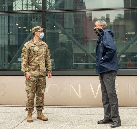 Mayor Bill de Blasio welcomes medical personnel NYC Mayor Bill de Blasio speaks to US Army major Sean Grady during welcoming ceremony for volunteer medical doctors and nurses of US Navy reserve outside of Javits Center outside of Jacob Javits Center where temporary hospital to treat patients has been set up New York New York United States Copyright: LevxRadin