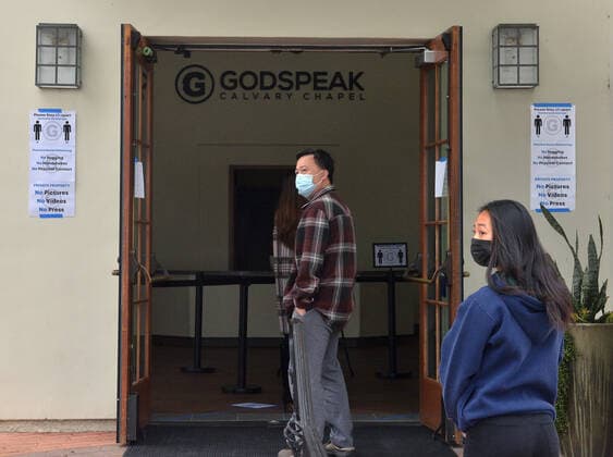 Parishioners practice social distancing guidelines as they line up to partake in the sacrament of communion-not services to kick off Holy Week despite county and state orders restricting non-essential travel at the Godspeak Calvary Chapel in the Newbury Park town of Thousand Oaks, California on Sunday, April 5, 2020. Millions of Christians around the world will spent Palm Sunday watching church service and taking communion from the comfort of their homes as they seek to abide stay-home orders intended to limit the spread of the coronavirus. File  LAP2020040504 JIMxRUYMEN
