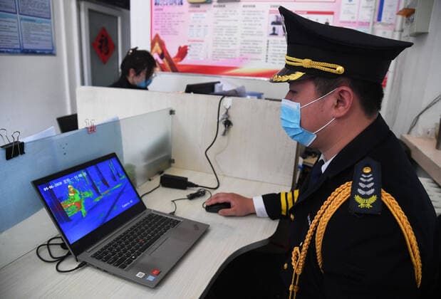 (200406) -- BEIJING, April 6, 2020 -- A member of staff checks the pictures sent by the 5G unmanned delivery car at the Beijing Institute of Technology in Beijing, capital of China, April 6, 2020. A 5G unmanned delivery car was put into use at the Beijing Institute of Technology, which can measure the temperature of people entering the campus, recognise facial information, and also can conduct no-touch delivery. ) CHINA-BEIJING-CAMPUS-UNMANNED DELIVERY CAR (CN) RenxChao 