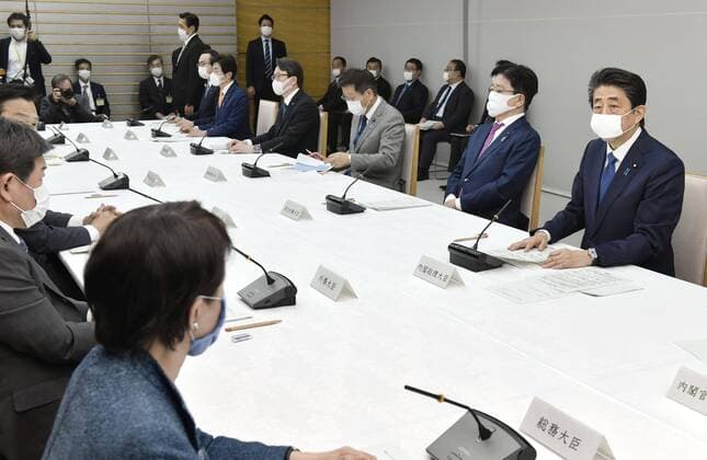 New coronavirus Japanese Prime Minister Shinzo Abe (R) attends a meeting of the government s coronavirus task force on April 6, 2020, in Tokyo. 