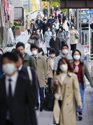 New coronavirus Masked people walk in Tokyo on April 6, 2020, amid concerns over the new coronavirus. 