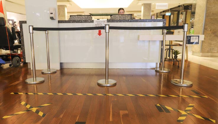(200406) -- CANBERRA, April 6, 2020 -- Photo taken on April 6, 2020 shows social distancing signs on the ground at a store in Canberra, Australia. (Photo by Xinhua) AUSTRALIA-CANBERRA-COVID-19-SOCIAL DISTANCING (CN) LiuxChangchang 