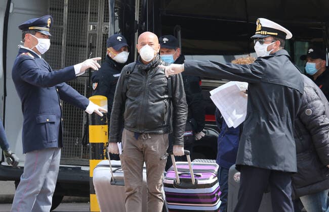 Coast Guard and police officers check apassenger just disembarked from the Catania Grimaldi ferry that brought at home 105 Italians citizens evaquated from Tuinisia. In Italy the lockdown still continue Government Decree declaring all of Italy a protected area to combat covid-19 - coronavirus infection, closing schools, public offices and shops.  Copyright: xCarloxHermannx xIPAx xKontrolabx