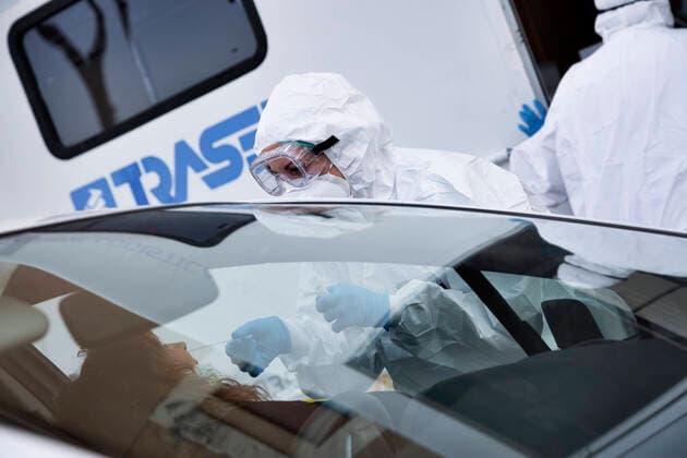 April 6, 2020, Roma, Roma, Italy: The collection of swab samples by medical staff in a drive-in testing center in Roma to check the Coronavirus (Covid-19).Health workers are dressing with protective suits..The Italian Government is still adopting the measure of a national lockout by closing all activities, except for essential services in an attempt to fight Coronavirus (COVID-19) .All the city, as all the whole country, is under quarantine and the movement are restricted to the necessary. Roma Italy - ZUMAt147 20200406_zip_t147_009 Copyright: xMatteoxTrevisanx
