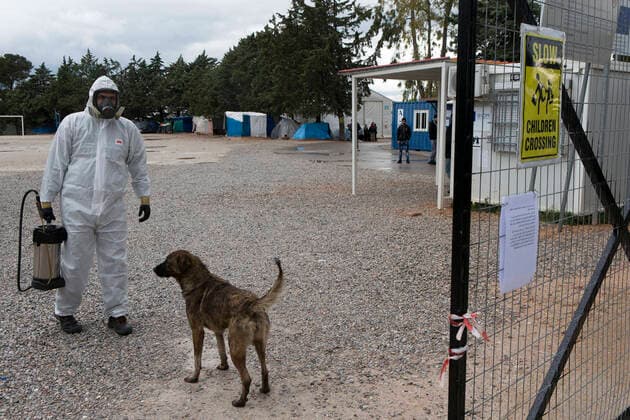 (200406) -- MALAKASA, April 6, 2020 -- A staff member carries disinfectant at the Malakasa camp near Athens, Greece, April 6, 2020. An Afghan migrant in Malakasa was confirmed to be infected with COVID-19 on Sunday, and the camp has been locked down since then. ) GREECE-MALAKASA-MIGRANTS-CAMP-COVID-19 MariosxLolos 