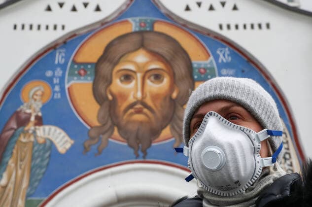 MOSCOW, RUSSIA - APRIL 6, 2020: A woman seen by the Church of St Nicholas in Tverskaya Zastava Square amid the ongoing COVID-19 coronavirus pandemic. The Moscow authorities imposed home isolation for all residents, regardless of their age, and restrictions on movement within the city, effective since March 30, 2020; a period off work with full pay was extended until April 30 nationwide as part of preventive measures to contain the spread of the COVID-19 infection. Sergei Karpukhin TASS  TS0D49B3