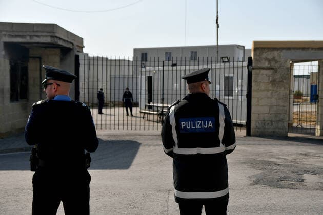 (200406) -- BIRZEBBUGA, April 6, 2020 -- Police officers are on duty in front of Hal Far open center in Birzebbuga, Malta, April 6, 2020. All the 1,000 residents at one of Malta s open centers have been placed on a mandatory 14-day lockdown after eight of them tested positive for coronavirus, Health Minister Chris Fearne announced on Sunday. He said the decision was taken following a risk assessment which revealed that the danger that the virus is passed to people outside the center would grow unless it is contained. (Photo by Xinhua) MALTA-BIRZEBBUGA-OPEN CENTER-LOCKDOWN JonathanxBorg 