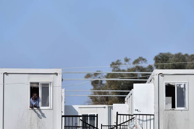(200406) -- BIRZEBBUGA, April 6, 2020 -- A resident is seen at Hal Far open center in Birzebbuga, Malta, April 6, 2020. All the 1,000 residents at one of Malta s open centers have been placed on a mandatory 14-day lockdown after eight of them tested positive for coronavirus, Health Minister Chris Fearne announced on Sunday. He said the decision was taken following a risk assessment which revealed that the danger that the virus is passed to people outside the center would grow unless it is contained. (Photo by Xinhua) MALTA-BIRZEBBUGA-OPEN CENTER-LOCKDOWN JonathanxBorg 