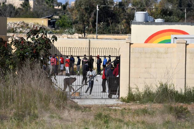 (200406) -- BIRZEBBUGA, April 6, 2020 -- Residents are seen at Hal Far open center in Birzebbuga, Malta, April 6, 2020. All the 1,000 residents at one of Malta s open centers have been placed on a mandatory 14-day lockdown after eight of them tested positive for coronavirus, Health Minister Chris Fearne announced on Sunday. He said the decision was taken following a risk assessment which revealed that the danger that the virus is passed to people outside the center would grow unless it is contained. (Photo by Xinhua) MALTA-BIRZEBBUGA-OPEN CENTER-LOCKDOWN JonathanxBorg 