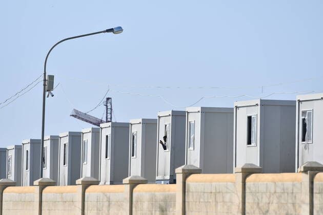 (200406) -- BIRZEBBUGA, April 6, 2020 -- A resident is seen at Hal Far open center in Birzebbuga, Malta, April 6, 2020. All the 1,000 residents at one of Malta s open centers have been placed on a mandatory 14-day lockdown after eight of them tested positive for coronavirus, Health Minister Chris Fearne announced on Sunday. He said the decision was taken following a risk assessment which revealed that the danger that the virus is passed to people outside the center would grow unless it is contained. (Photo by Xinhua) MALTA-BIRZEBBUGA-OPEN CENTER-LOCKDOWN JonathanxBorg 