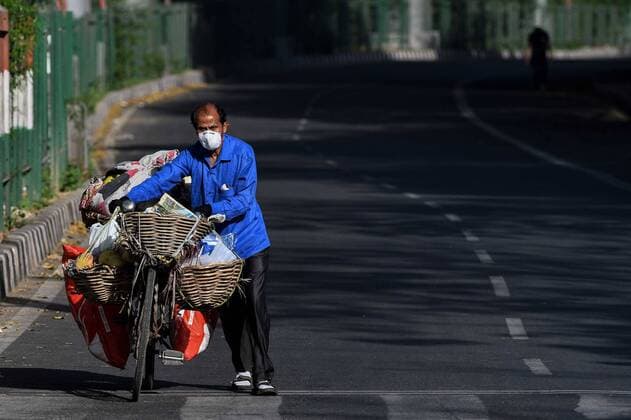 NEW DELHI, INDIA - APRIL 6: A fruit seller wears a protective mask while he pushes his cycle n day thirteen of the 21-day nationwide lockdown to check the spread of coronavirus, at Amar Colony on April 6, 2020 in New Delhi, India. (Photo by Biplov Bhuyan Hindustan Times) Three Week Lockdown In India To Stop Spread Of Coronavirus COVID-19