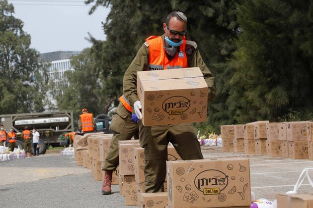 (200406) -- BNEI BRAK, April 6, 2020 (Xinhua) -- Israeli soldiers collect and pack for distributing food packages to local citizens in the central Israeli city of Bnei Brak, on April 6, 2020. According to Israel s Ministry of Health, a total of 474 people in Israel were tested positive for COVID-19 on Monday, bringing the tally of infections to 8,904. (Photo by Gil Cohen Magen Xinhua) MIDEAST-BNEI BRAK-COVID-19 