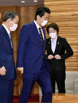 New coronavirus Japanese Prime Minister Shinzo Abe heads to a regular Cabinet meeting at his office in Tokyo on April 7, 2020. He is set to declare a state of emergency in Tokyo and other big cities later in the day in response to a recent surge in coronavirus infections. 