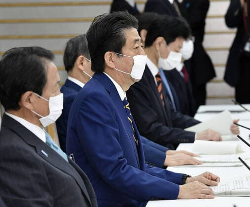 New coronavirus Japanese Prime Minister Shinzo Abe (C) attends an informal policy meeting at his office in Tokyo on April 7, 2020. The meeting led by the government and the ruling coalition was held ahead of the scheduled declaration later in the day by Abe of a state of emergency in Tokyo and other big cities in view of a recent surge in coronavirus infections. 