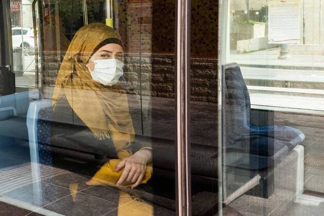 April 7, 2020, Jerusalem, Israel: A woman complies with Ministry of Health decrees wearing a face mask on public transportation in Jerusalem in light of the Coronavirus outbreak. Jerusalem Israel - ZUMAa126 20200407_zap_a126_010 Copyright: xNirxAlonx