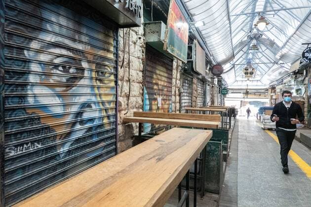 April 7, 2020, Jerusalem, Israel: Israelis hurry about their last minute shopping and preparations for Passover which begins on sunset 8th April, 2020. The iconic Shuk Mahane Yehuda Market in Jerusalem is nearly empty due to the COVID-19 crisis. Jerusalem Israel - ZUMAa126 20200407_zap_a126_013 Copyright: xNirxAlonx
