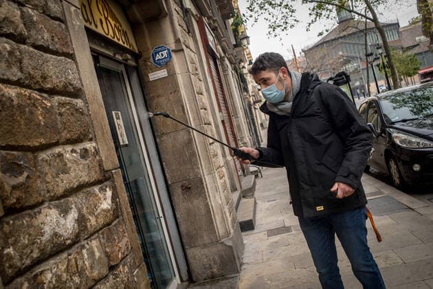 April 7, 2020, Barcelona, Catalonia, Spain: The owner of a supermarket disinfects the access to his shop just before opening. After four-day fall, daily coronavirus deaths in Spain rise to 743. The total number of fatalities in the country now stands at 13,798, with 140,510 confirmed infections. Barcelona Spain - ZUMAb137 20200407_zap_b137_004 Copyright: xJordixBoixareux