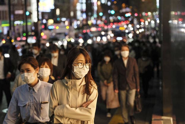 New coronavirus People wearing face masks walk in Tokyo s Shinjuku area on April 7, 2020. Earlier in the day, Japanese Prime Minister Shinzo Abe declared a state of emergency for Tokyo, Osaka and five other prefectures to curb the spread of the new coronavirus. 