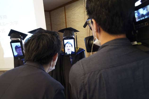 April 7, 2020, Tokyo, Japan: A Japanese University has held the world s first online graduation ceremony using robots due to the coronavirus pandemic...Students at Business Breakthrough University in Tokyo didn t get a traditional ceremony, but had the next best thing using newme telepresensence robots and a tablet hosting a Zoom call...Graduates had the experience of walking across the stage and accepting their diplomas at the Hotel Grand Palace in Tokyo, virtually on March 28, all while self-isolating at home...The robots were dressed in a cap and gown and fitted with tablets on their heads, allowing students to show their face using Zoom...When the moderator called the name, a newme wearing a graduation gown and hat from BBT University appeared on the tablet with the face of the graduate who operated it, and the diploma was hande - ZUMAc218 20200407_zia_c218_015 Copyright: xCOVERxImagesx